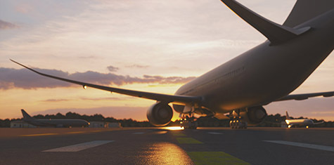 Jet airplane on runway at sunset