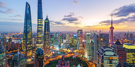 Shanghai, China skyline lit up at dusk