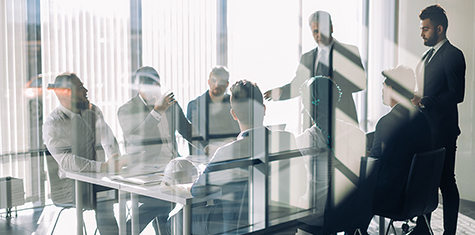 Multiple people holding a meeting in a conference room