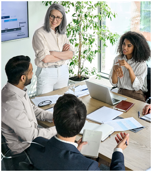 Group of four professionals holding meeting around a conference table